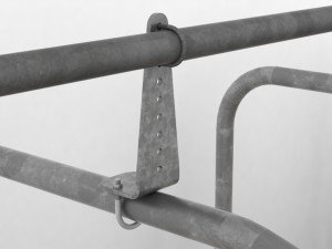 Close-up of the galvanised headrail-riser bracket on a WCCP precast concrete cattle cubicle, Devon