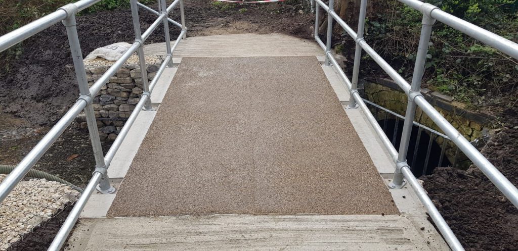 Finished precast concrete culvert deck with resin-bound surface and galvanised handrail crossing by WCCP Devon