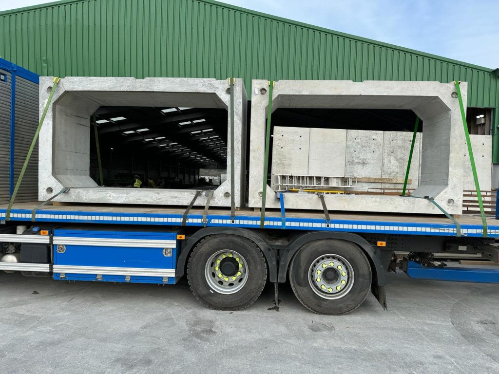 Two large precast concrete box culverts strapped to a flatbed lorry leaving the WCCP yard for delivery, Devon