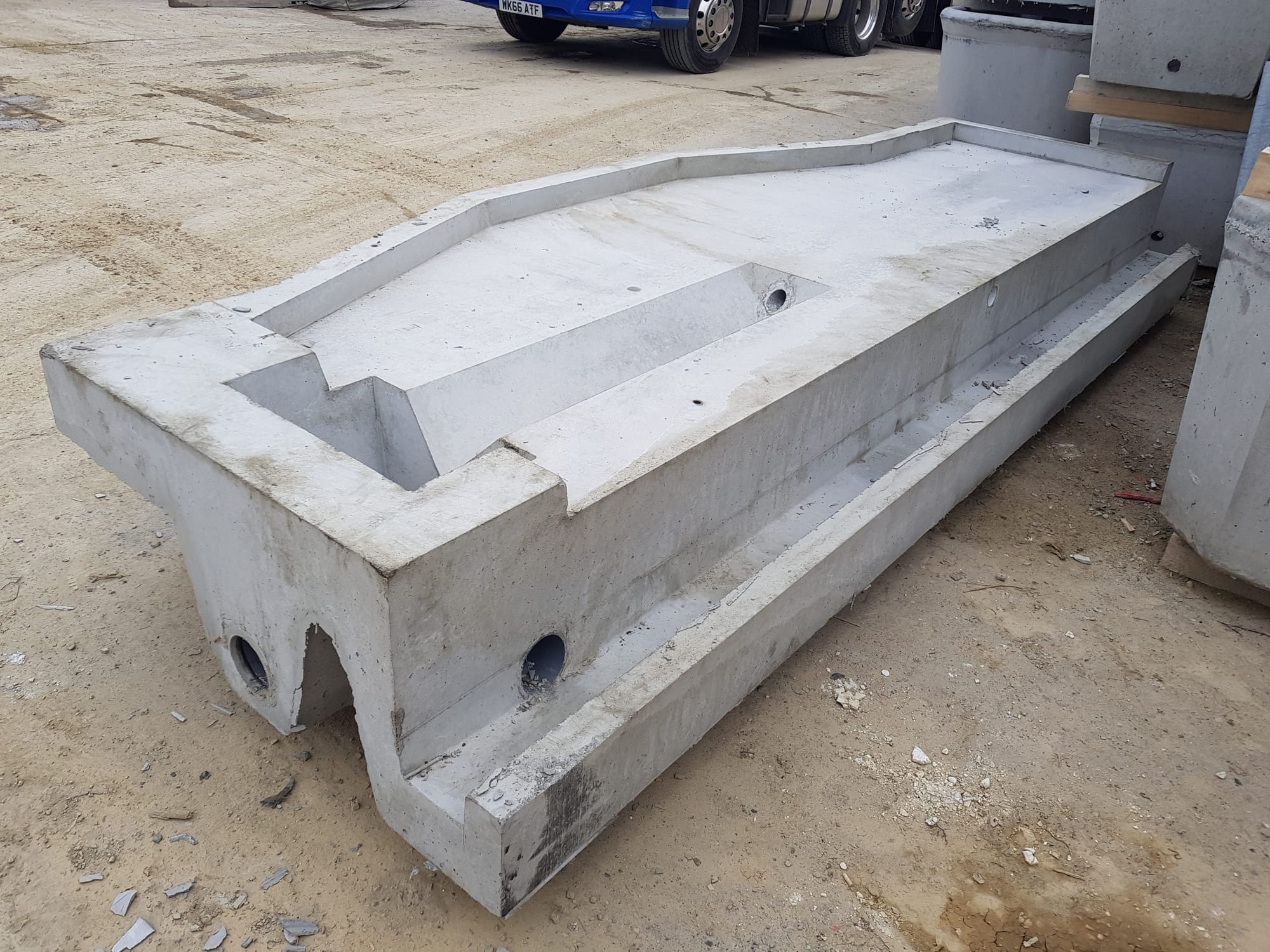 Top view of cast precast concrete DeLaval VMS robot base showing socket connections for 110mm soil pipe, Devon
