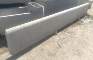 Black cattle feeding from a precast concrete feed wall on-farm, supplied by WCCP Devon