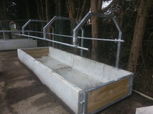 Precast concrete cattle feed trough with galvanised feed-rail gate frame by WCCP Devon