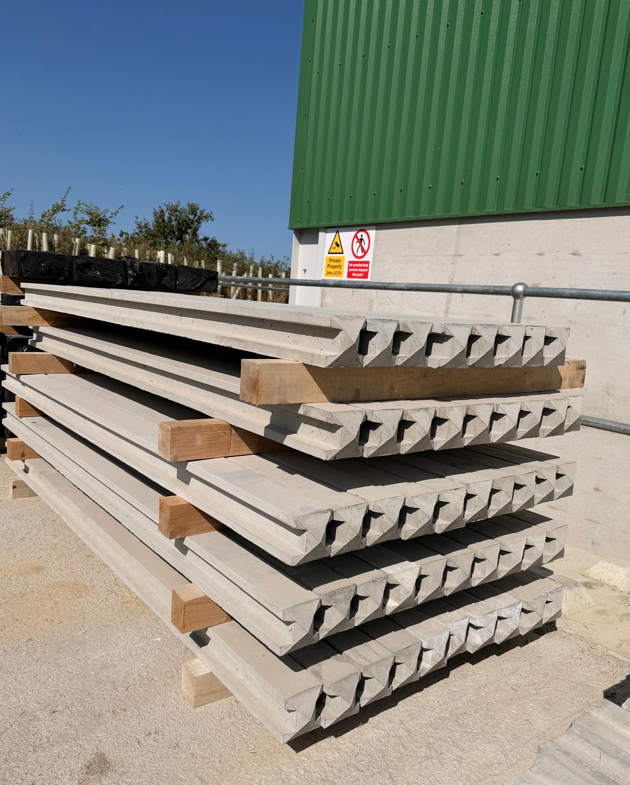 Precast concrete fence rails with tenoned ends stacked at the WCCP yard, ready for despatch