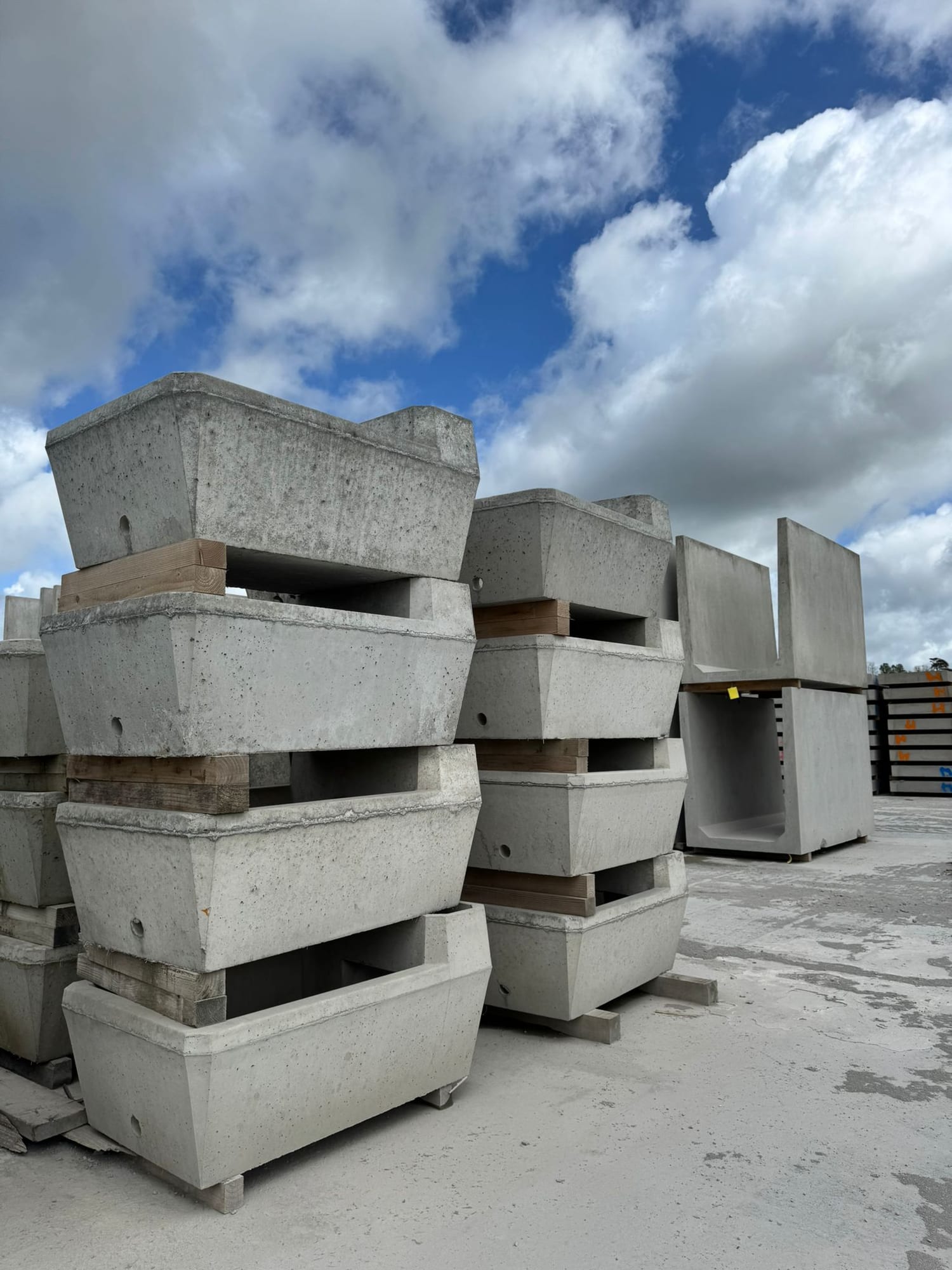 Precast concrete headwall sections stacked on pallets with a box culvert visible behind at the WCCP yard, Chilsworthy, Devon