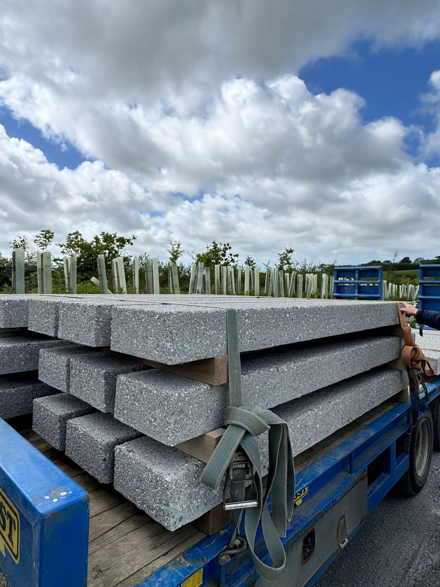 Precast concrete lintels and beams strapped on a blue Herbst flatbed trailer ready for delivery from the WCCP yard, Chilsworthy, Devon