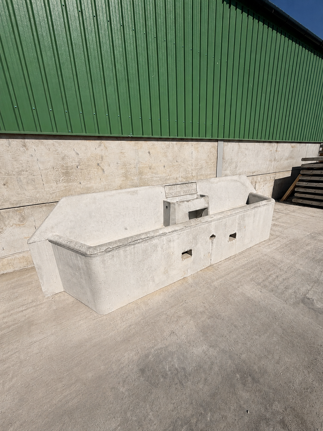 WCCP precast concrete cattle drinking trough with cast-in "West Country Concrete Products" branding, Holsworthy yard